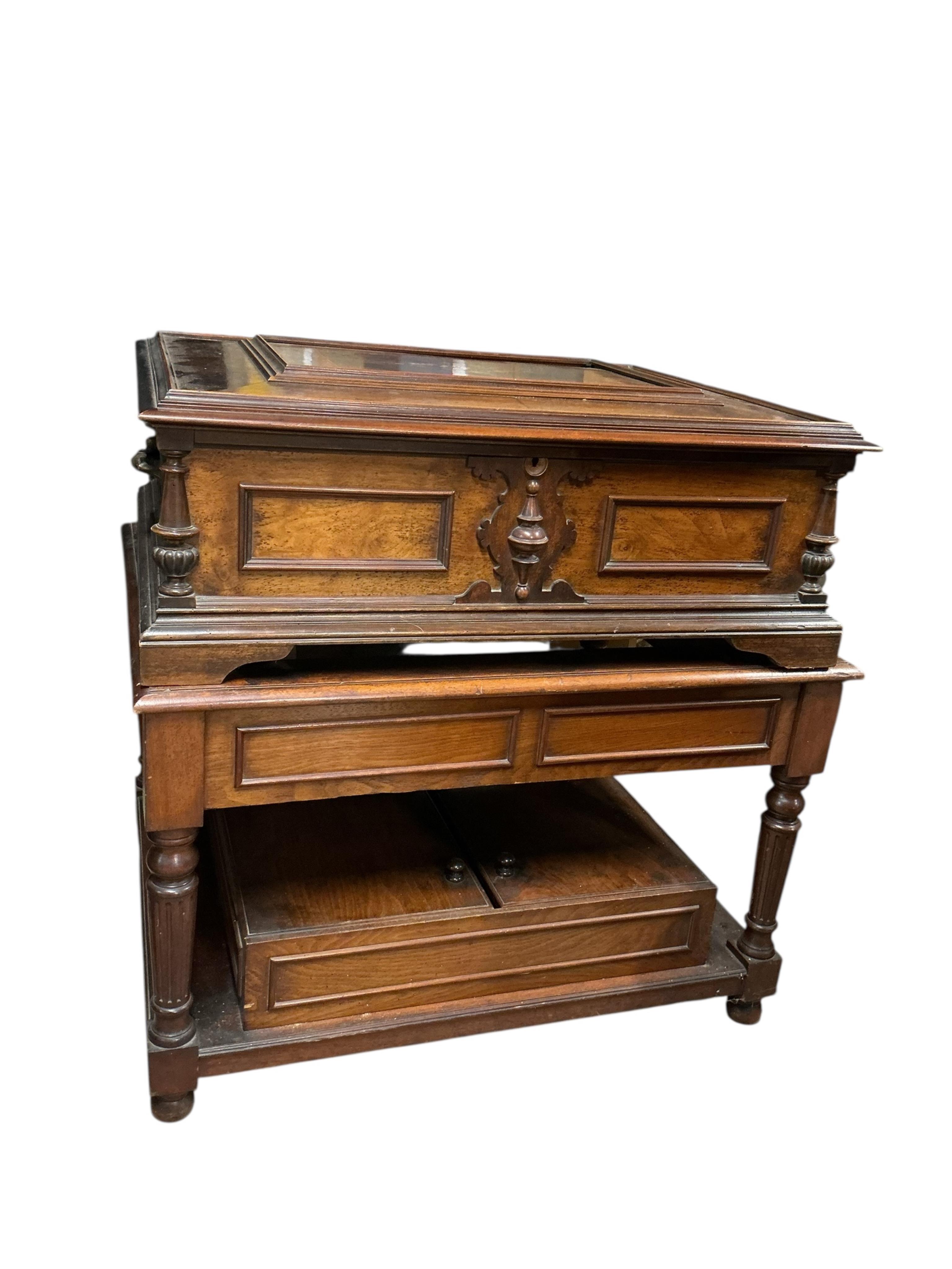 A substantial early 20th century inlaid walnut cased tabletop Orpheus polyphon on a floor standing base containing a compartment for storing the discs, together with thirty-seven 57.5cm diameter discs, and a winding hand